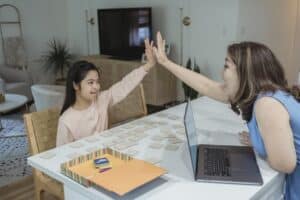 Mother and Daughter Having a High Five